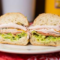 Deli Turkey Sandwich · Includes mustard, mayonnaise, lettuce, tomato, pickles, onions, peperoncino, jalapeno, oil, ...