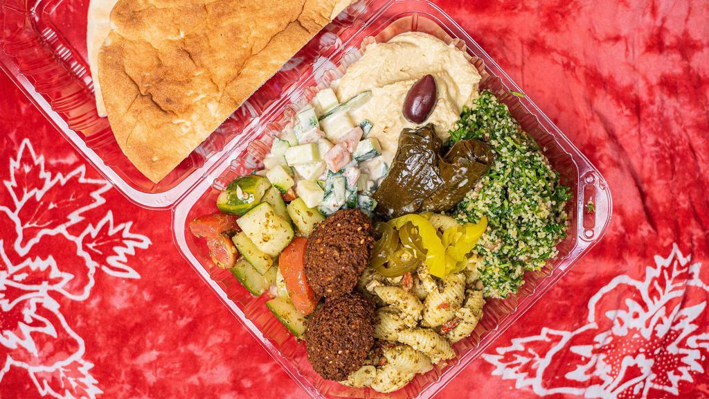Mediterranean Plate · Includes falafel, dolmas, tabbouleh salad, hummus, tahini salad, tomato and cucumber salad, mixed mediterranean olives, with pita bread.