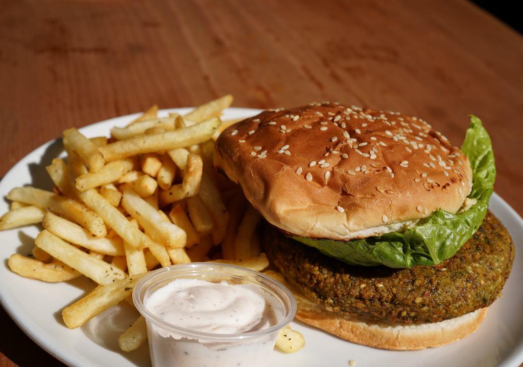 Falafel Burger · Served with French Fries. Hummus spread, pickles, lettuce, tomato & red onions in sesame bun.
