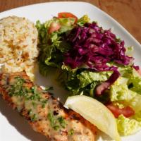 Grilled Salmon · served with rice & salad. Marinated with extra virgin olive oil, lemon, and fresh oregano.