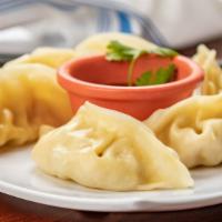 A5. Pot Stickers · Filled with cabbage, chicken, onion, and soy sauce.