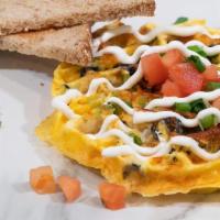 Veggie Womelette · Green Bell Pepper, Tomatoes, Olives, Green Onions, Tater Tots, Shredded Cheddar Cheese, Eggs