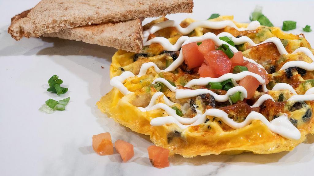 Veggie Womelette · Green Bell Pepper, Tomatoes, Olives, Green Onions, Tater Tots, Shredded Cheddar Cheese, Eggs