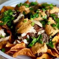 Fork & Knife Nachos · Gluten-free. Local corn tortilla chips, tossed with melted Daiya cheese. Topped with black b...