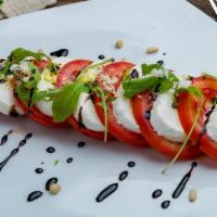 Caprese Salad · Mozzarella, fresh tomato salad with EVOO, basil, and balsamic vinegar reduction. <br />*EVOO...