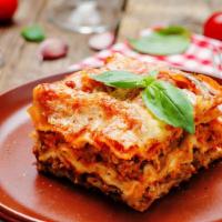 Lasagna al Ragù · Our meat Sauce lasagna made with EVOO and loaded with mozzarella and parmesan cheese.