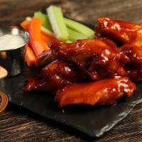 Sweet Chili · 8 traditional wings tossed in sweet chili (mild heat), served with carrots & celery and a di...