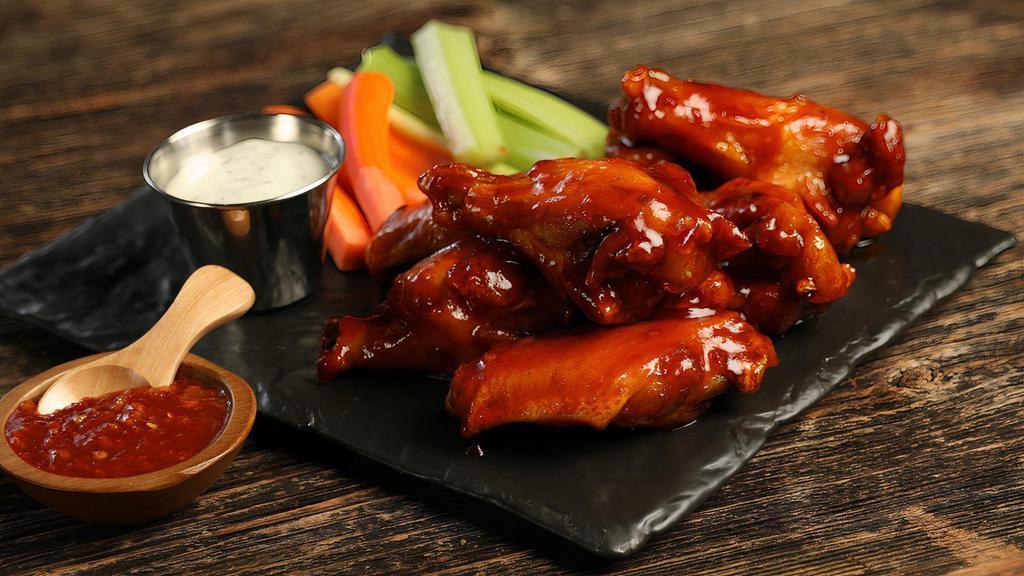 Sweet Chili · 8 traditional wings tossed in sweet chili (mild heat), served with carrots & celery and a dipping sauce of your choice.