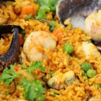 Arroz con Mariscos · A creamy, jasmine rice - Paella - clams, mussels, calamari, scallops, and a Peruvian scallop...