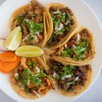 Regular Taco · Choice of meat, onion, cilantro, and salsa served on a corn tortilla.