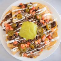 Super Nachos · Tortilla chips covered with your choice of meat, beans, cheese, sour cream, tomatoes, jalape...