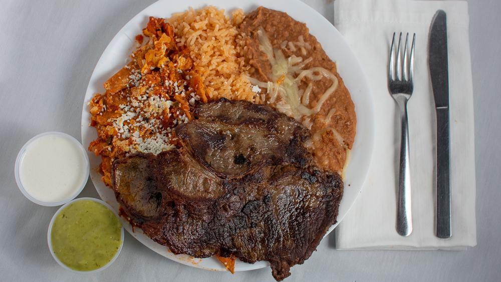 Chilaquiles Served with Steak · Steak served with salsa, rice, beans, egg, sour cream, and guacamole.