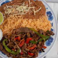 Steak Fajitas · Steak served with rice, beans, guacamole, and tortillas.