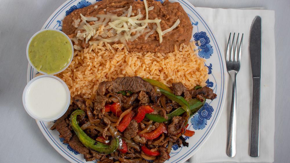 Steak Fajitas · Steak served with rice, beans, guacamole, and tortillas.
