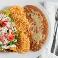 Flautas (Beef) · Three beef flautas served with rice and beans.