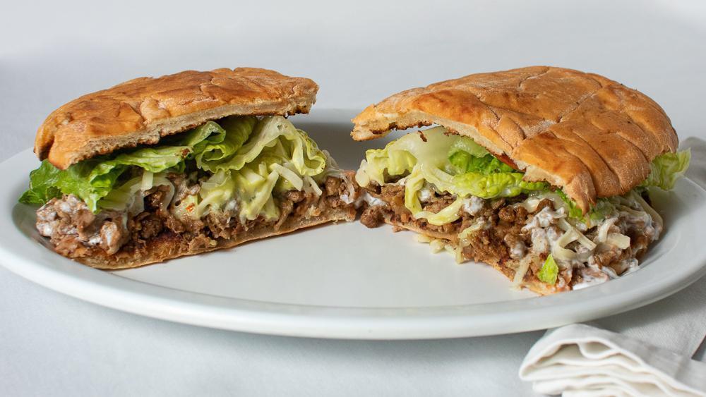 Torta · Choice of meat served with mayo, tomatoes, onion, lettuce, cheese, sour cream, and guacamole.