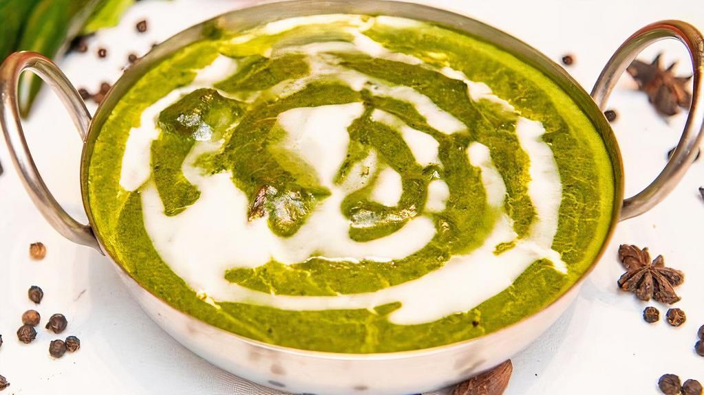 Palak Paneer · Soft cottage cheese purée of spinach and seasoned with garlic, garam masala, cream and other spices.