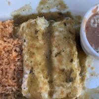 Enchiladas Suizas · Two enchiladas filled with cheese, chicken, beef or pork, topped with a green sauce, sour cr...