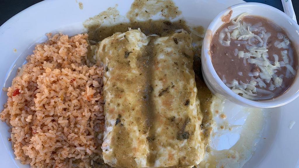 Enchiladas Suizas · Two enchiladas filled with cheese, chicken, beef or pork, topped with a green sauce, sour cream, and cheese.