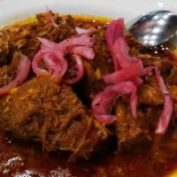 Cochinita Pibil · Yucatán dish, pork marinated in achiote sauce, rice, tortillas.