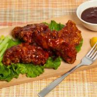 BBQ Traditional Wings · Delicious cooked wings tossed in BBQ sauce and seasoned to perfection.