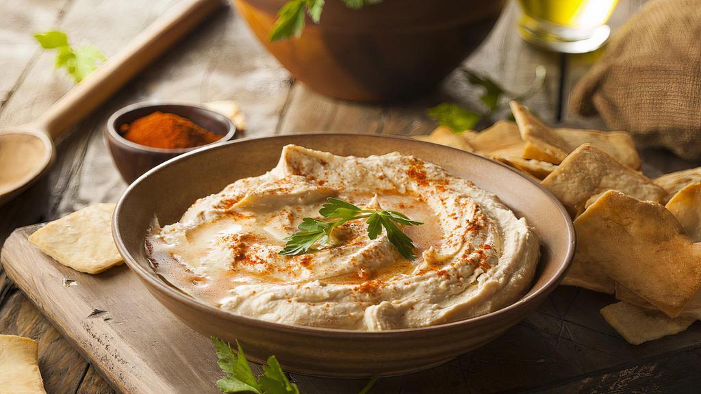 Hummus · A delightful dip of garbanzo beans with garlic, lemon juice, tahini and olive oil.