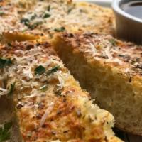 Garlic Bread · housemade white bread topped with a creamy butter, garlic oregano, parmasean cheese, and par...