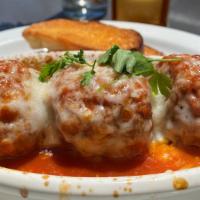 Polpette · housemade beef meatballs with house marinara sauce, mozzarella, parsley and crostini