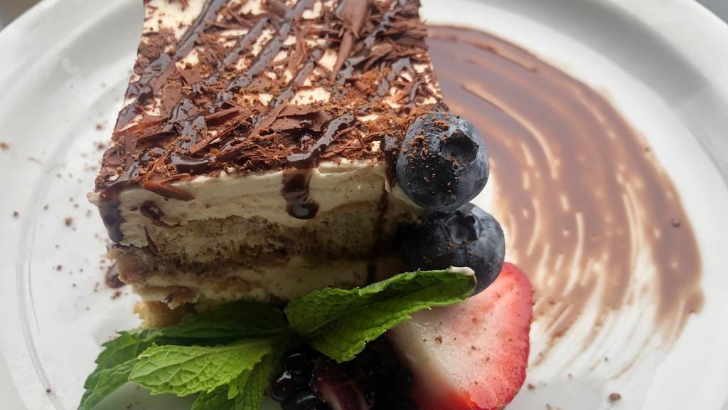 Tiramisu · traditional Italian dessert made with lady finger soaked in espresso, layered with mascarpone cream topped with chocolate shavings