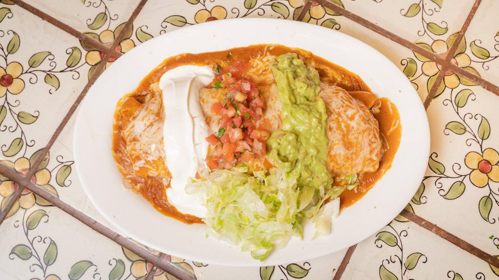 Burrito Mojado · Super burrito covered in choice of red or green sauce.