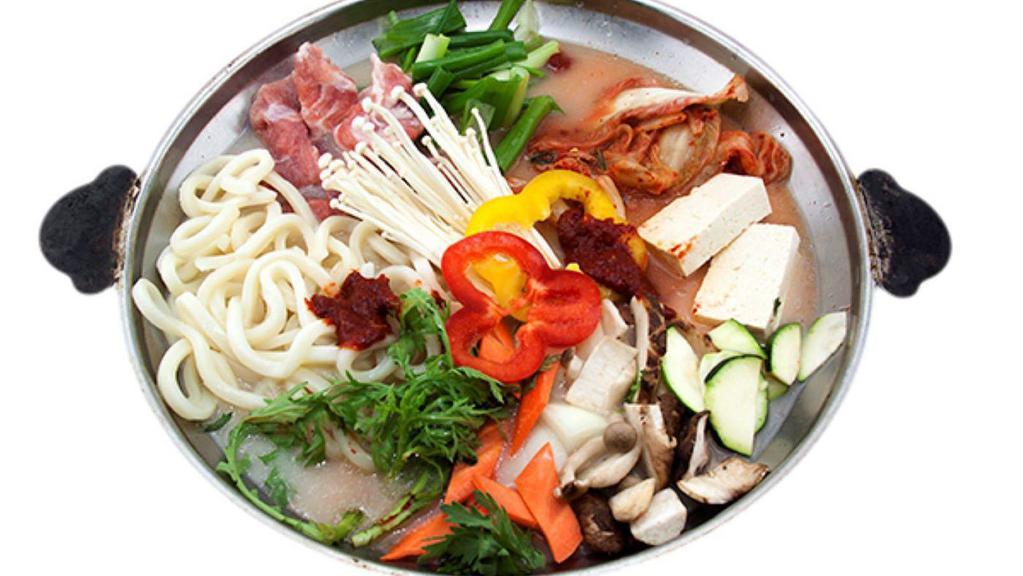 Kimchi Jungol 김치전골 · Hot assorted casserole served with vegetables, tofu, pork, and udon noodles in beef bone broth. (2-3 serving)