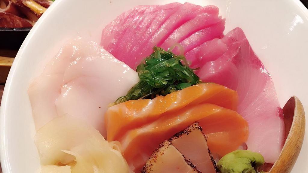 Rainbow Chirashi · Salmon, tuna, hamachi, butter fish, avocado, mango, seaweed salad, crab, tobiko and sushi rice.