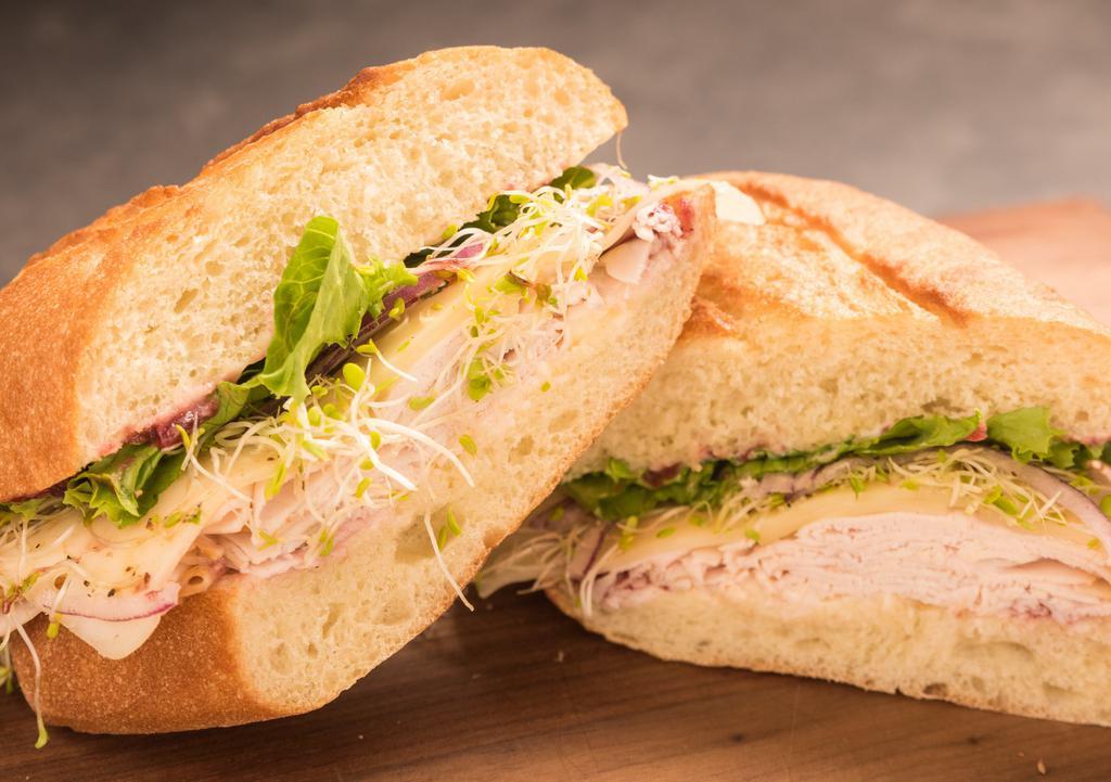 Cranturkey · slow roasted turkey, swiss, sprouts, leaf lettuce, mayo, cranberry compote on wheat roll