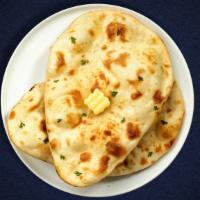 Butter Buzzer Naan · Freshly baked bread in a clay oven garnished with butter