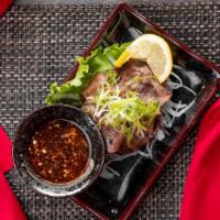 Tan Shio · grilled beef tongue, onions, green onions, ponzu garlic sauce