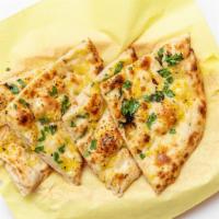 Garlic Naan · Soft bread with garlic freshly baked in tandoor.