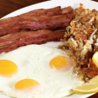 Tiffany's Classic · Tiff's Hash, three eggs, choice of one hot link, four bacon strips, two country sausage patt...