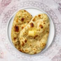 Garlic Naan · Freshly baked bread in a clay oven garnished with garlic and butter