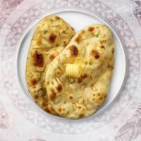 Garlic Cheese Naan · Freshly baked bread in a clay oven garnished with garlic and cheese.