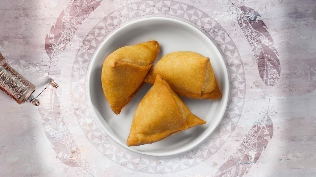 Vegetable Samosa · Idaho potatoes mixed in a curry marinate & fried in a crispy wheat layer. Served with tamarind chutney.