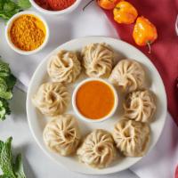 Chicken Momo ( 7 Pieces) · Steamed dumplings filled with minced chicken, onion, garlic, ginger, and cilantro.