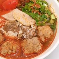 H13. Bun Rieu (minced crab noodle) · Vermicelli soup with minced crab mixed with ground pork and eggs, also serve with pork patty...