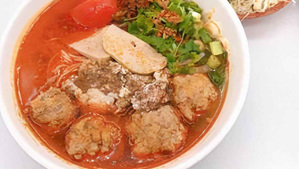 H13. Bun Rieu (minced crab noodle) · Vermicelli soup with minced crab mixed with ground pork and eggs, also serve with pork patty, and tofu.