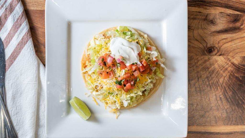 Super Taco · Your choice of meat lettuce pico de gallo guacamole cheese and sour cream on a large soft corn tortilla.