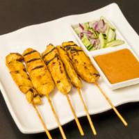 A1. Satay Chicken (5 pcs) · Marinated in house spices, served with peanut sauce & cucumber salad.