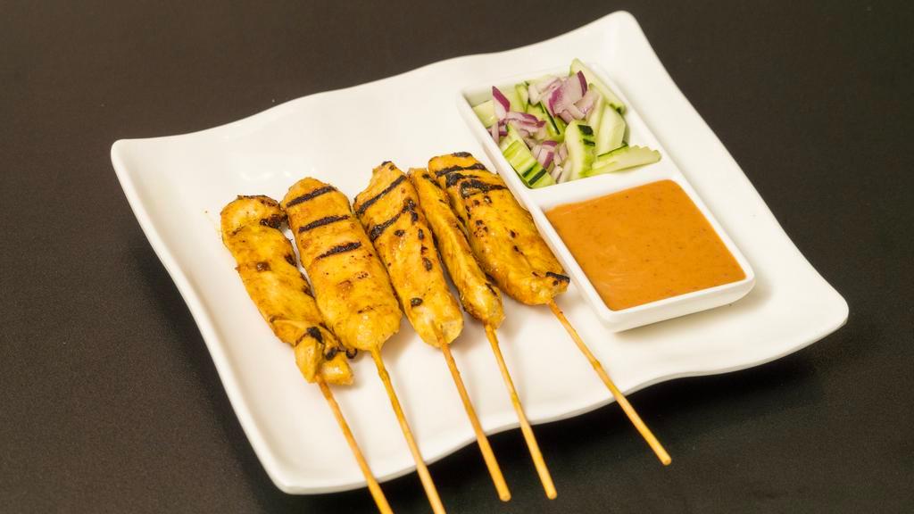 A1. Satay Chicken (5 pcs) · Marinated in house spices, served with peanut sauce & cucumber salad.