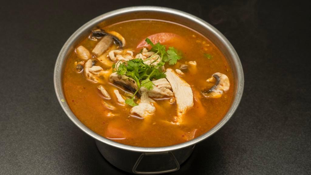 S1. Tom Yum  · Mild Spicy.  A blend of spices with lemongrass broth, lime juice, mushrooms, tomato and a choice of meat.
