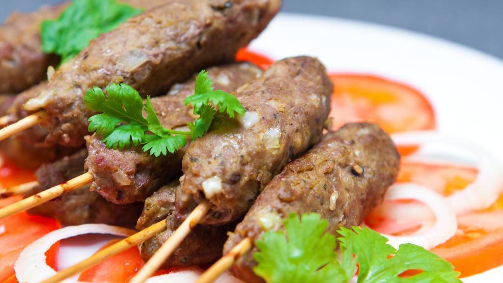 Lamb Seekh Kabab · Ground lamb marinated with delicious spices. Cooked in a Clay Oven. Served on Skewers.