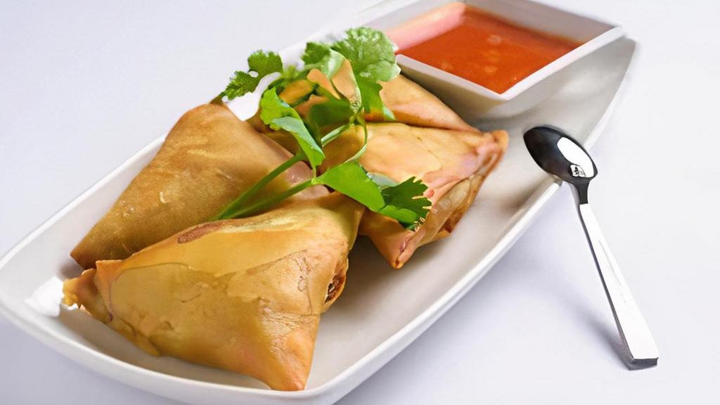 (C) Samosas (Vegetarian) · Rice flour turnover filled with potatoes, red onions, peas, carrots and a blend of ten unique spices served with special house sauce.