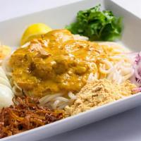 Nan Gyi Dok · Our traditional Burmese dish with rice noodles topped with coconut chicken sauce, yellow bea...